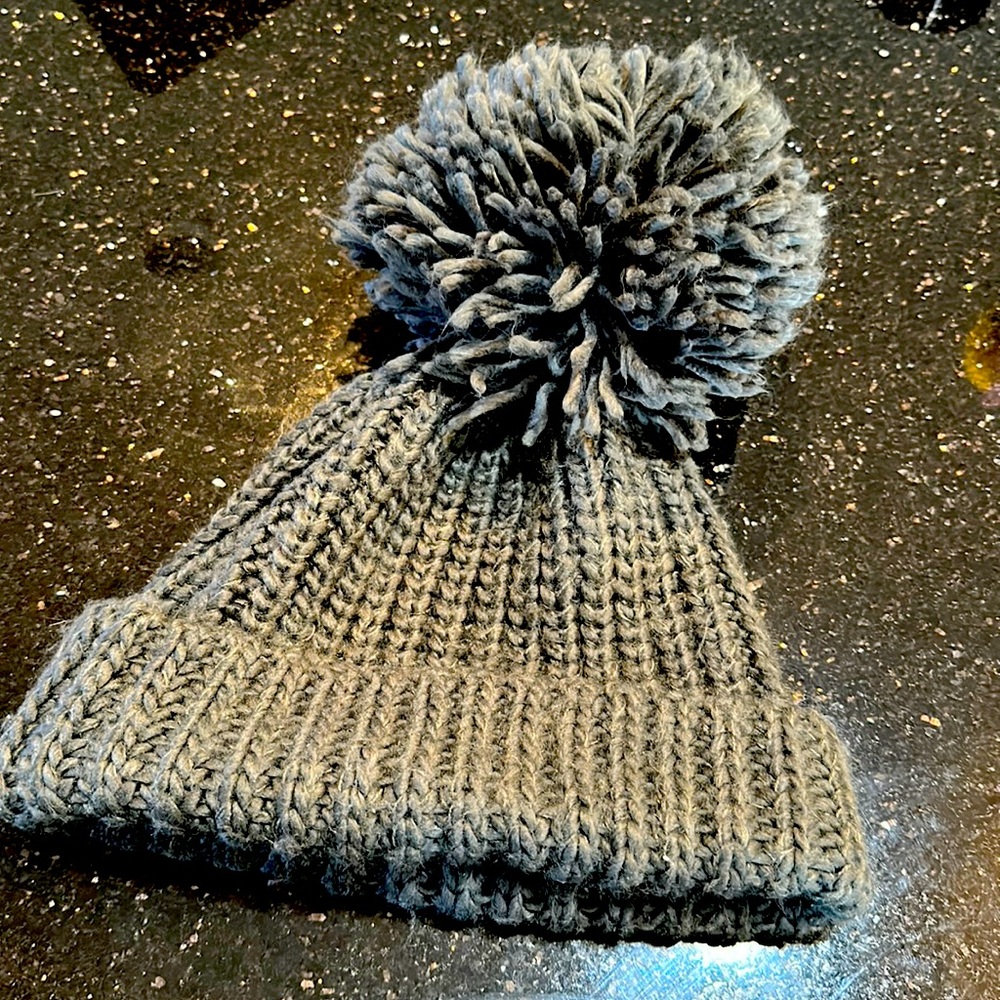 Beanie in charcoal gray with big puff ball on top